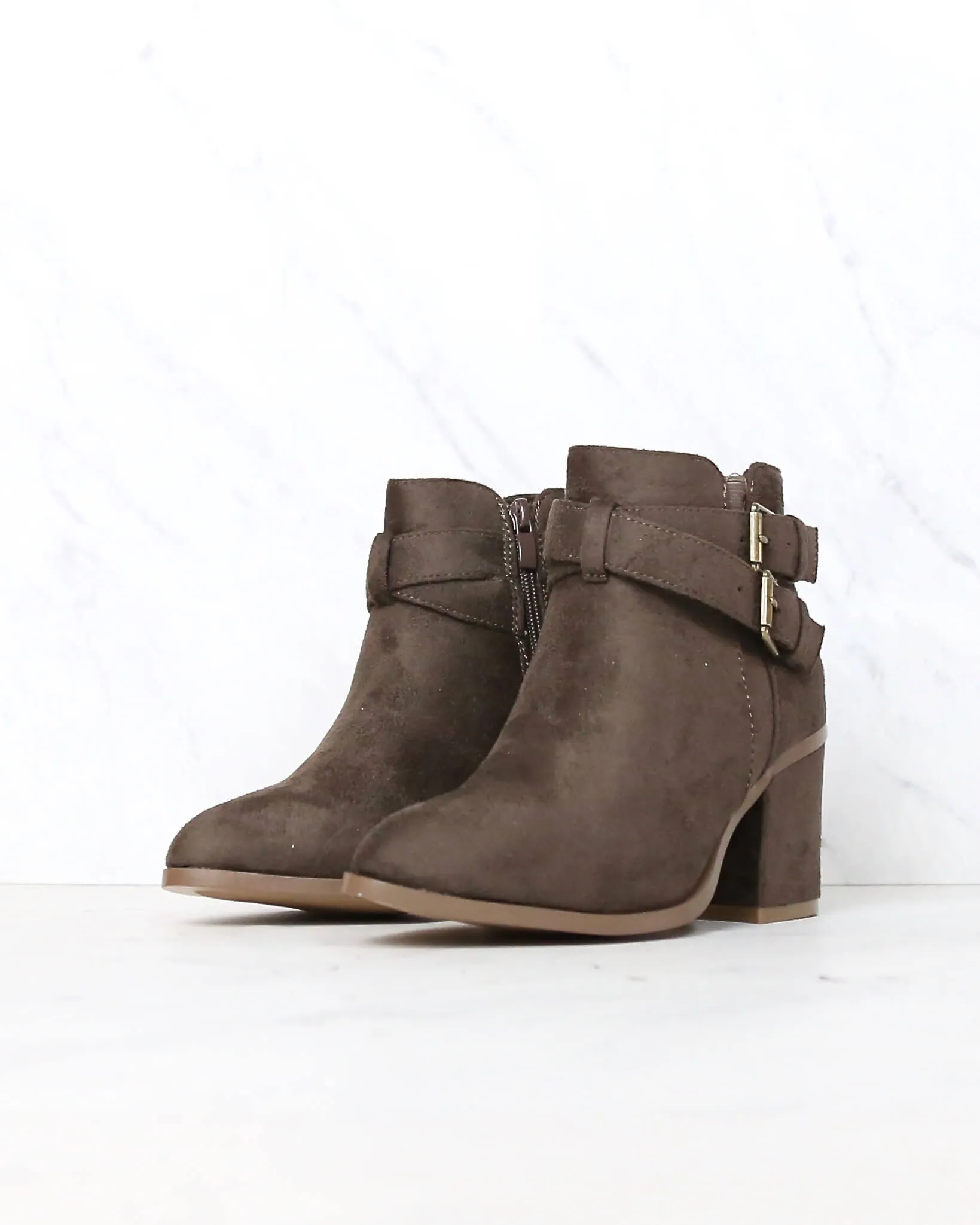 A Grand Entrance Faux Suede Ankle Bootie With Buckle Detail in More Colors